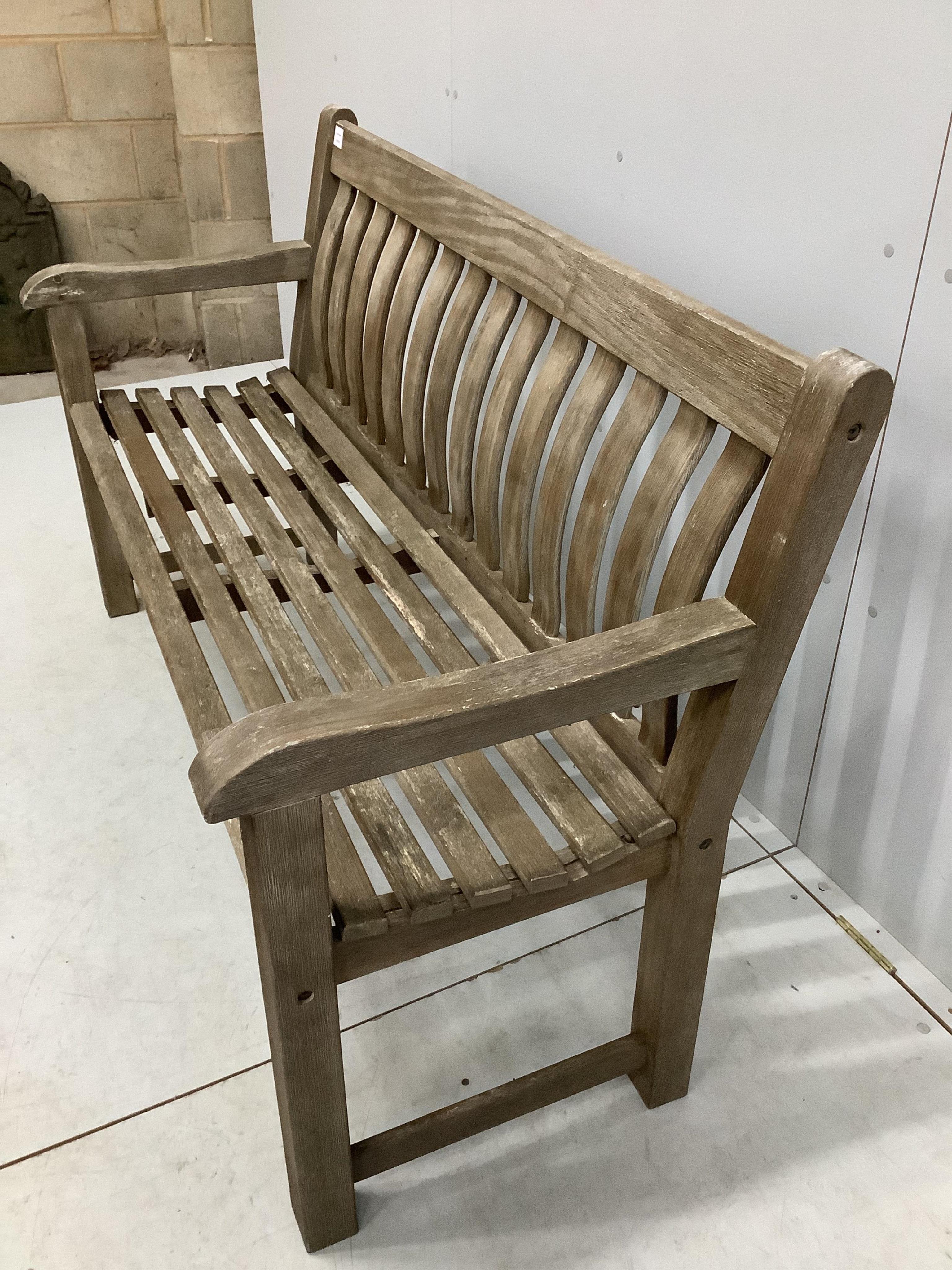 A weathered teak slatted garden bench, width 146cm, depth 52cm, height 92cm. Condition - good but weathered